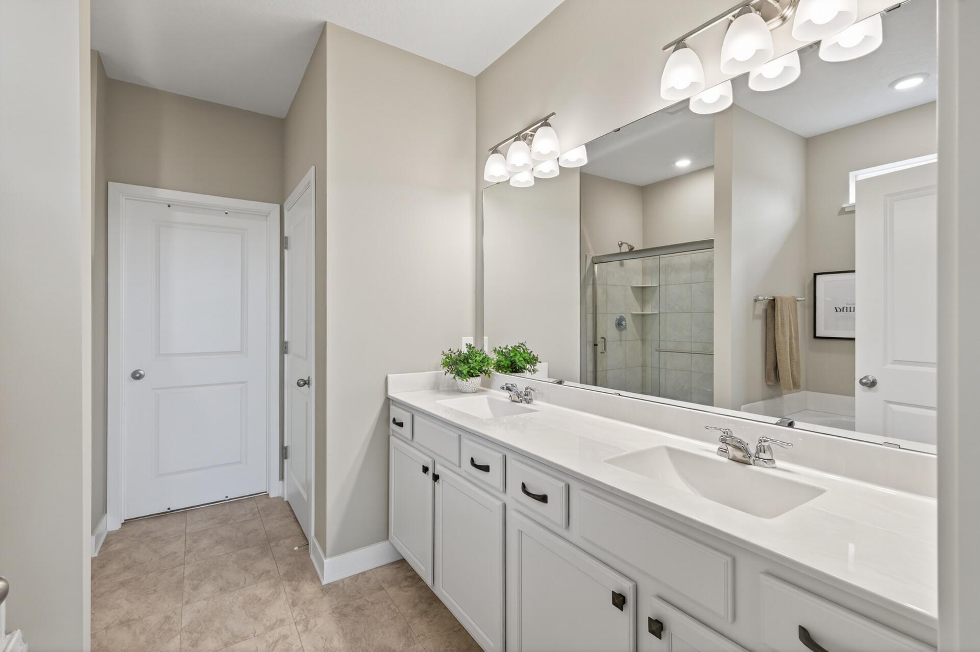 Serene retreat to wake up to, with two separate sinks for effortless mornings. Love the walk-in closet. Plus have a soaking tub and shower!