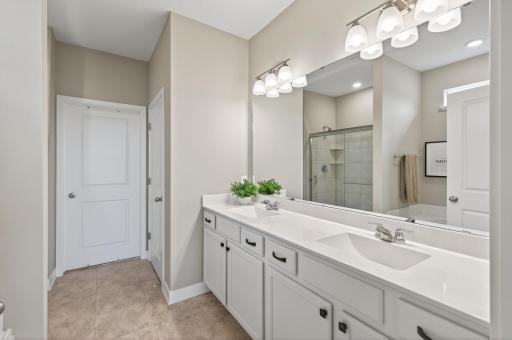 Serene retreat to wake up to, with two separate sinks for effortless mornings. Love the custom designed walk-in closet. Rare find these days, with a soaking tub and shower!