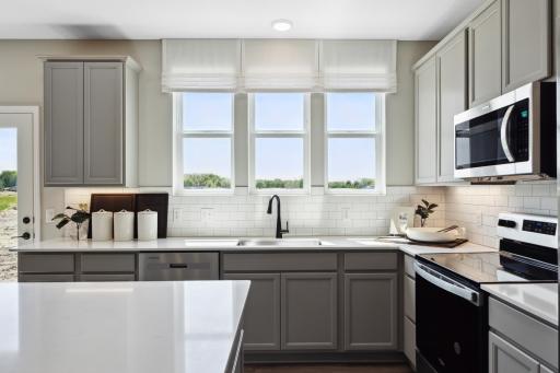 Kitchen with three windows to the backyard