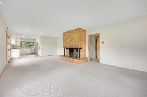 Open concept living room/dining room/kitchen features an amazing fireplace.