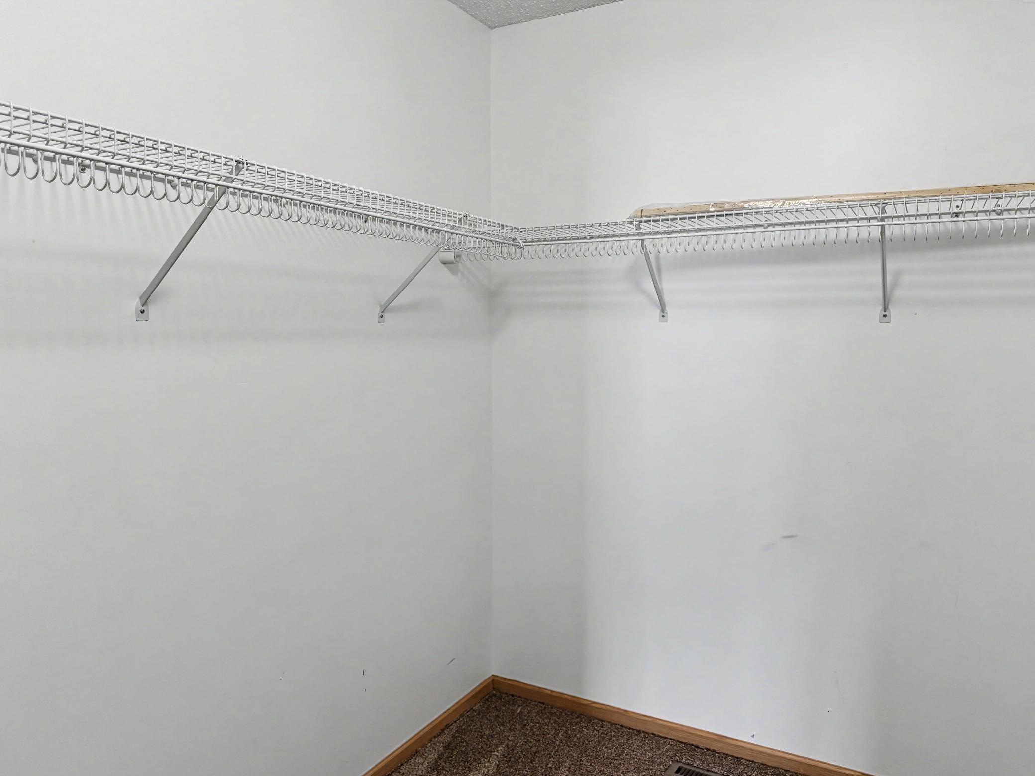 Primary bedroom walk in closet