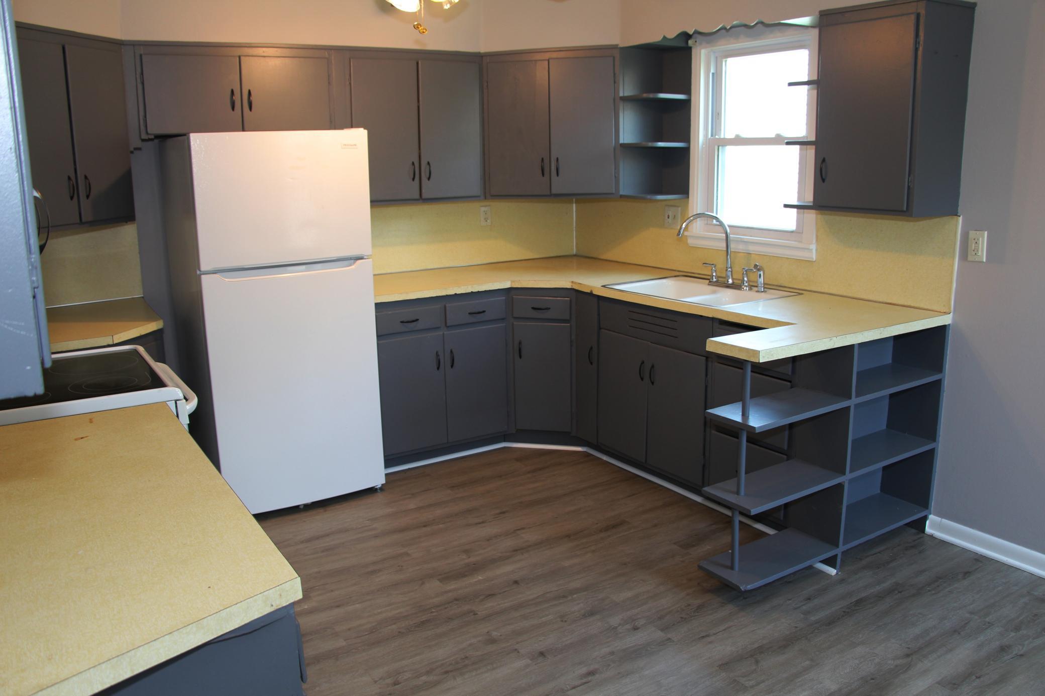 Here is another view of the kitchen. Features newer flooring and a new kitchen window with plenty of natural light.