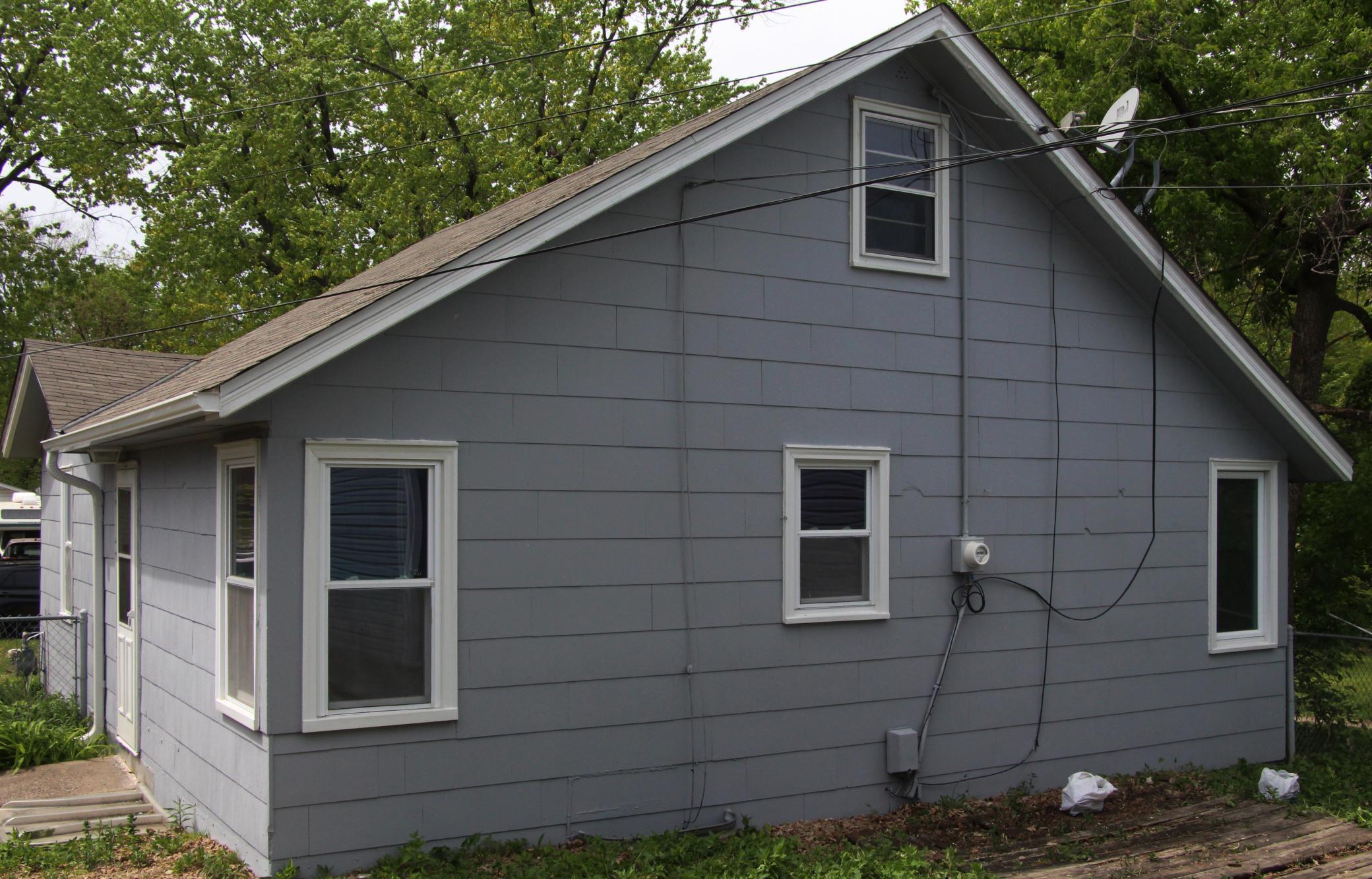 Here is a view of the back of the home. Please note that the old wooden patio has been removed now and it was filled with fresh black dirt and will be seeded.