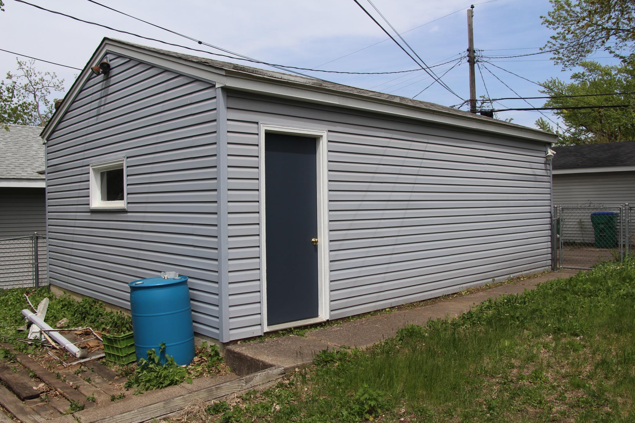 This is the garageFeatures your service door and a concrete sidwalk.