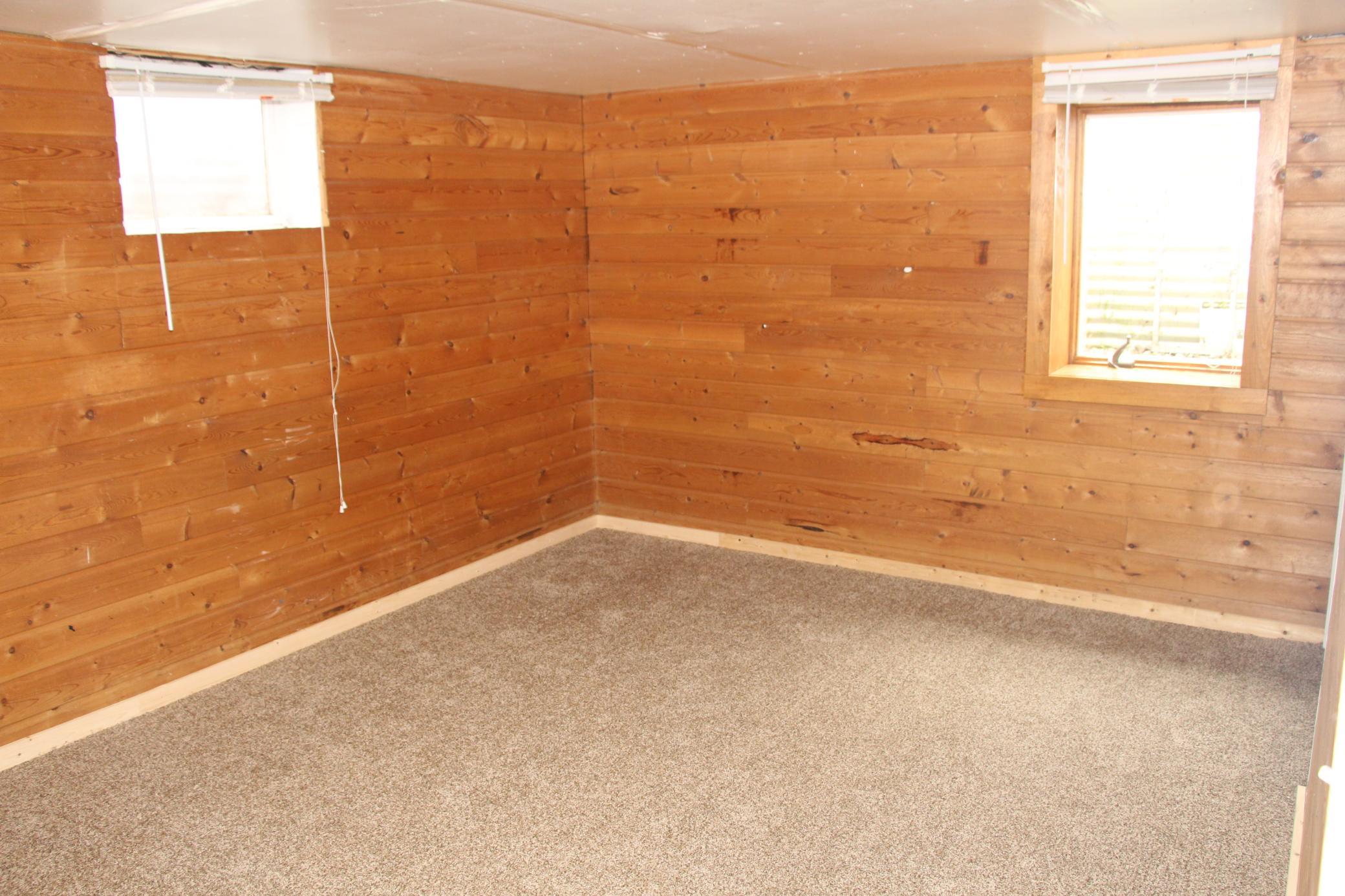 This is the large Bedroom in the basement featuring a large walk in closet, egress window, and brand new carpeting.