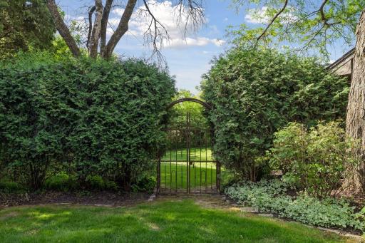 Ornamental fencing leads to a garden paradise