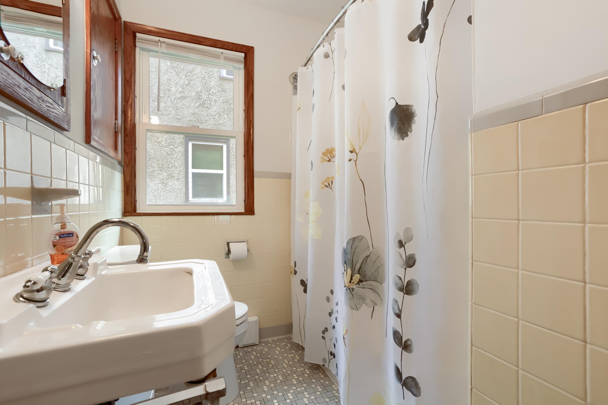 The main floor bathroom is quite charming. There is even a clothes chute in the hallway to drop your laundry down.