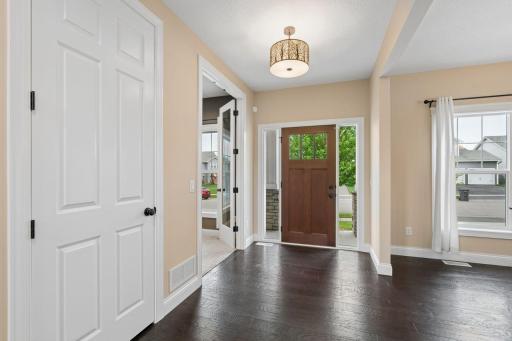 Simply stunning and light filled entry-way. 6" enameled baseboards trim throughout with gorgeous wide-plank hardwood floors.