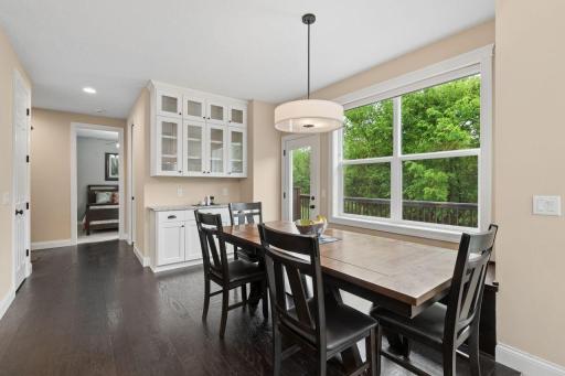 The informal dining area offers a built-in credenza boasting the same finishes as the kitchen- complete with under cabinet lighting!