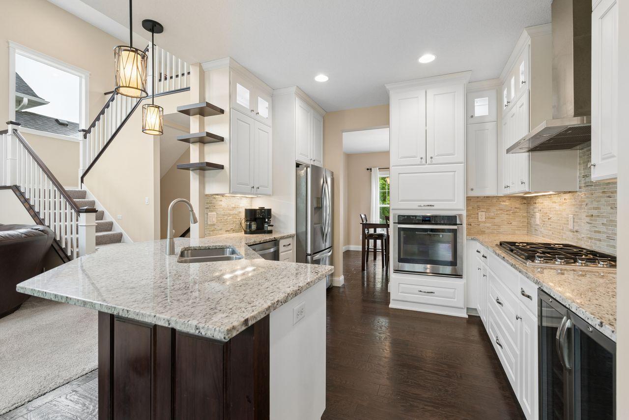 Wow! All the appliances and amenities you want! 5-gas burner capital range; built-in beverage center, stainless steel appliances and under cabinet lighting. All effortlessly tied together with a beautiful backsplash.