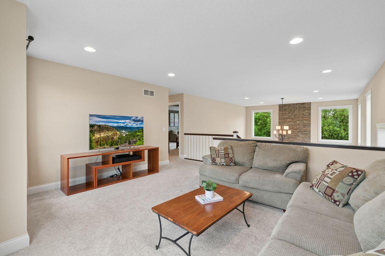This spacious loft serves as another living space. Sharing views of the woods in the backyard, the 2-story fireplace, and the southern exposure of the front yard. You'll love the 6" enameled trim carried throughout the upstairs!