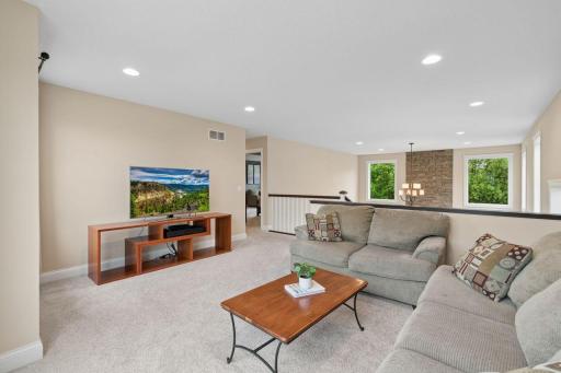 This spacious loft serves as another living space. Sharing views of the woods in the backyard, the 2-story fireplace, and the southern exposure of the front yard. You'll love the 6" enameled trim carried throughout the upstairs!