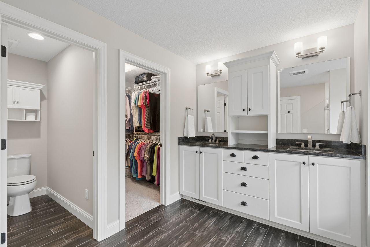 This primary back room is luxurious. Private toilet closet, impressive walk-in closet, and a double vanity complete with storage.
