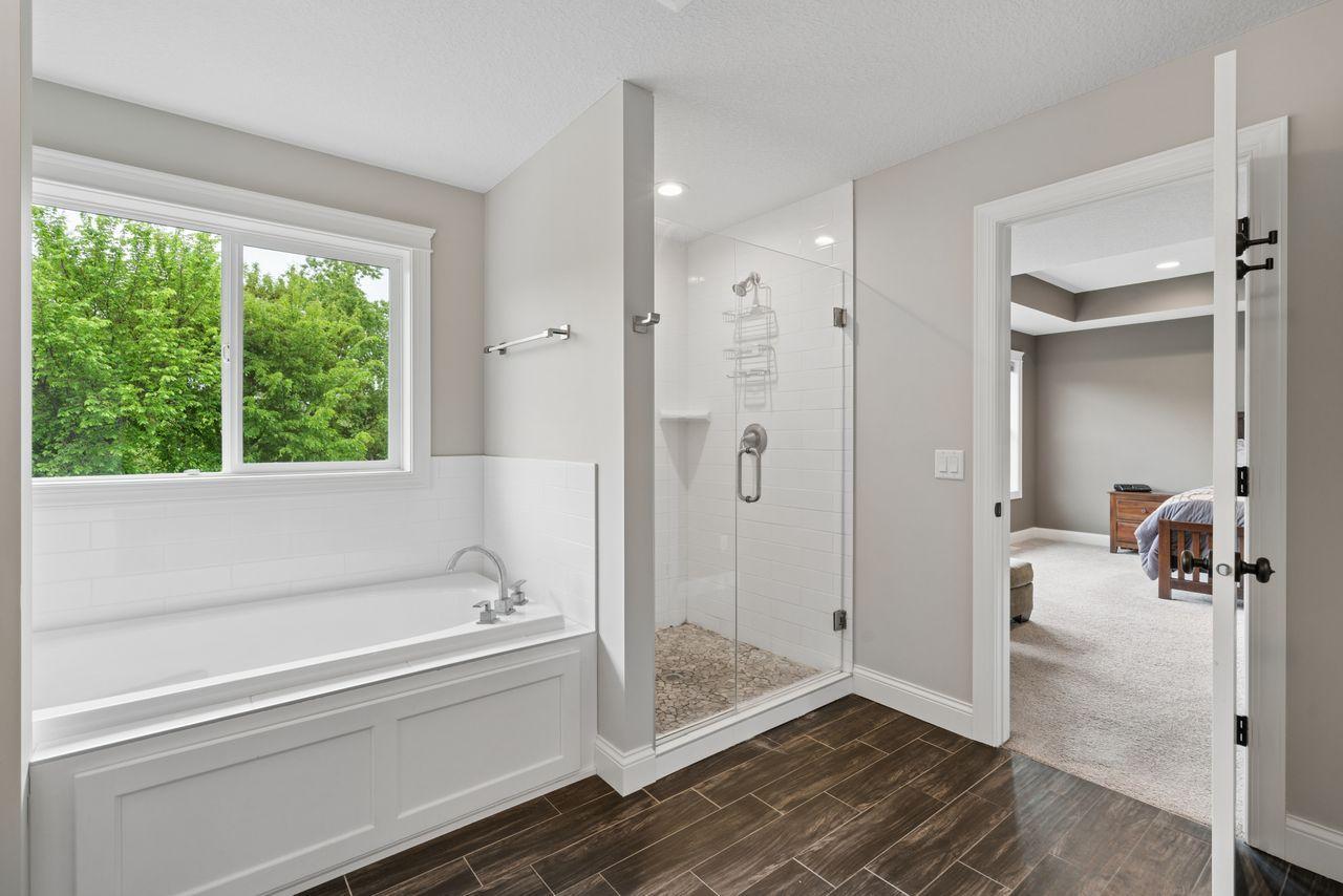 A large soaking tub and a step-in shower with incredible tile work throughout- you'll love unwinding here!