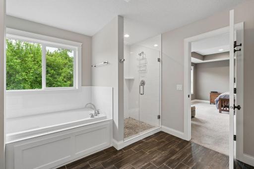 A large soaking tub and a step-in shower with incredible tile work throughout- you'll love unwinding here!