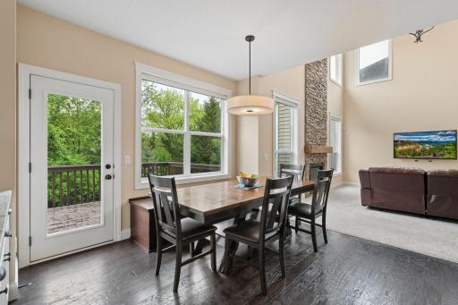 Informal dining with a built-in bench for storage. The windows and access to the deck showcase the tree-lined backyard.