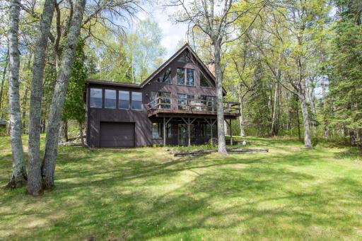Spacious lakeside deck offers the perfect setting for entertaining, relaxing, and soaking in panoramic lake views.