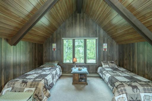 Upper-level loft provides additional sleeping space and flexibility for guests or a cozy retreat.