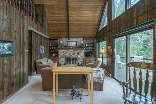 Vaulted ceilings and a cozy wood-burning fireplace create a welcoming lakeside atmosphere.