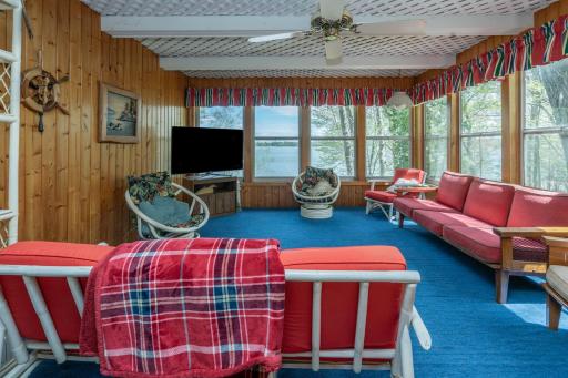 Inviting sunroom offers the perfect spot for morning coffee overlooking the lake.