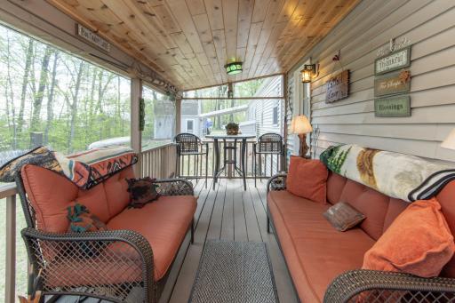 Enjoy peaceful mornings and breathtaking sunsets from the attached 3-season porch overlooking the water.