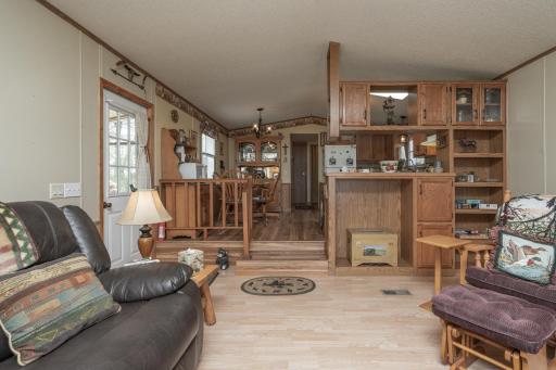 Thoughtfully updated interior with newer flooring, lighting, and ceiling fans throughout the home.