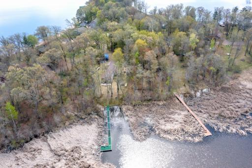 A birdâs-eye view reveals the perfect balance of shoreline, mature trees, and outdoor living spaces.