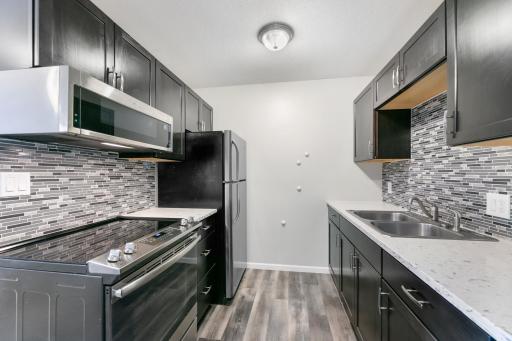 Beautiful updated cabinets and backsplash in kitchen