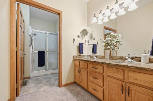 The oversized vanity features dual sinks, great lighting and plenty of storage. You'll appreciate the smart design with a door separating the vanity from the walk-in shower and toilet area.