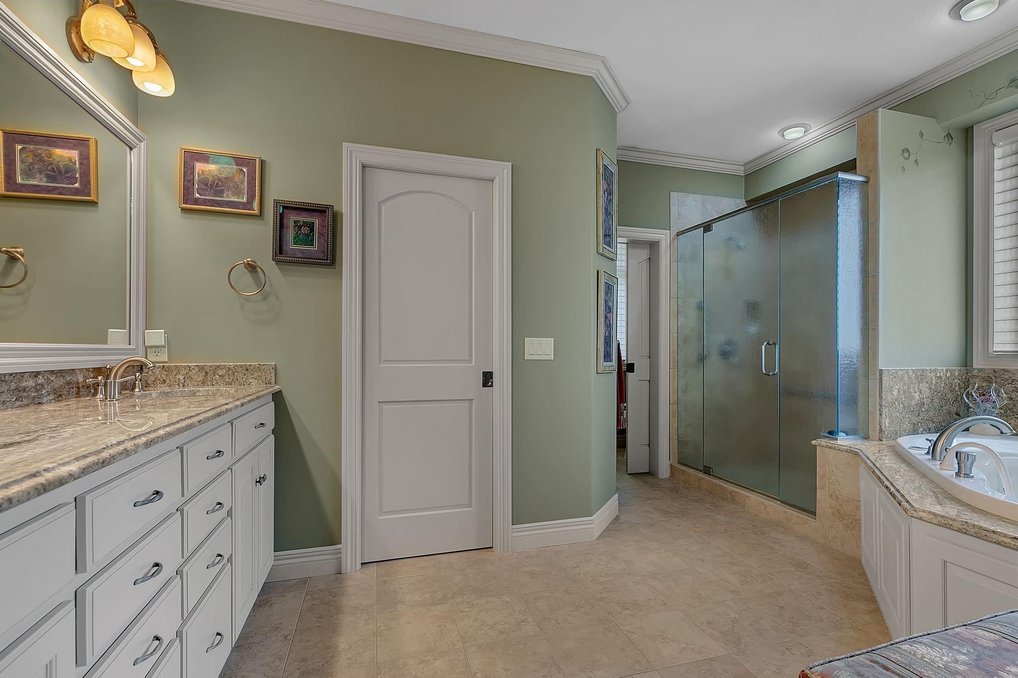 Private bathroom, steps into the walk in closet.
