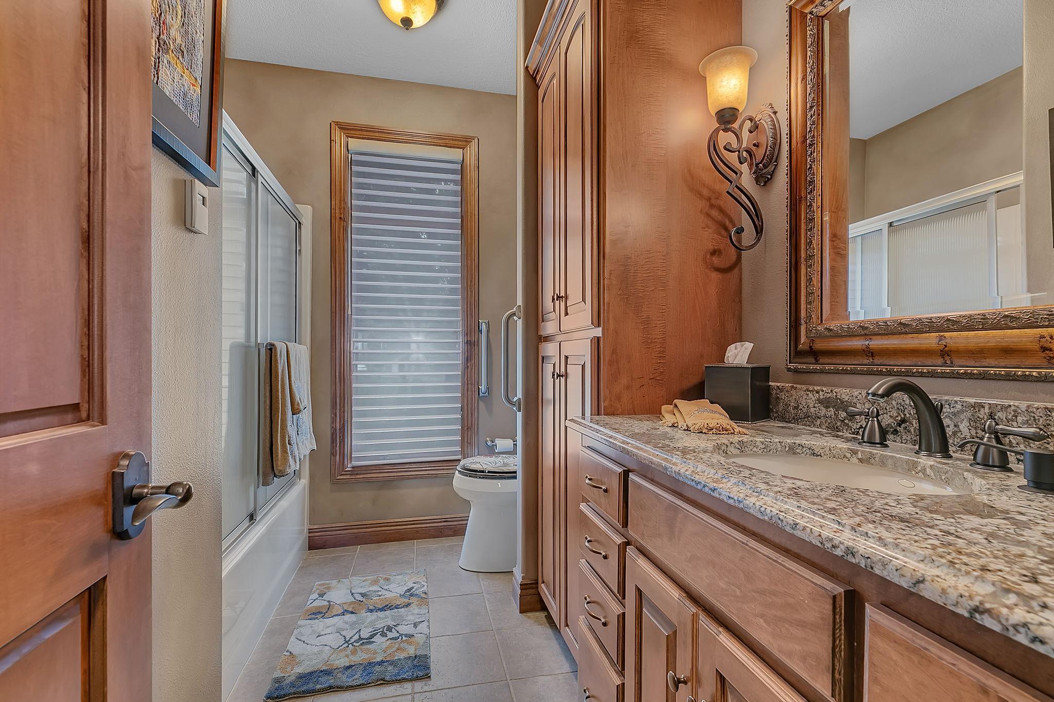 Full main floor bathroom with a surplus of options for storage.