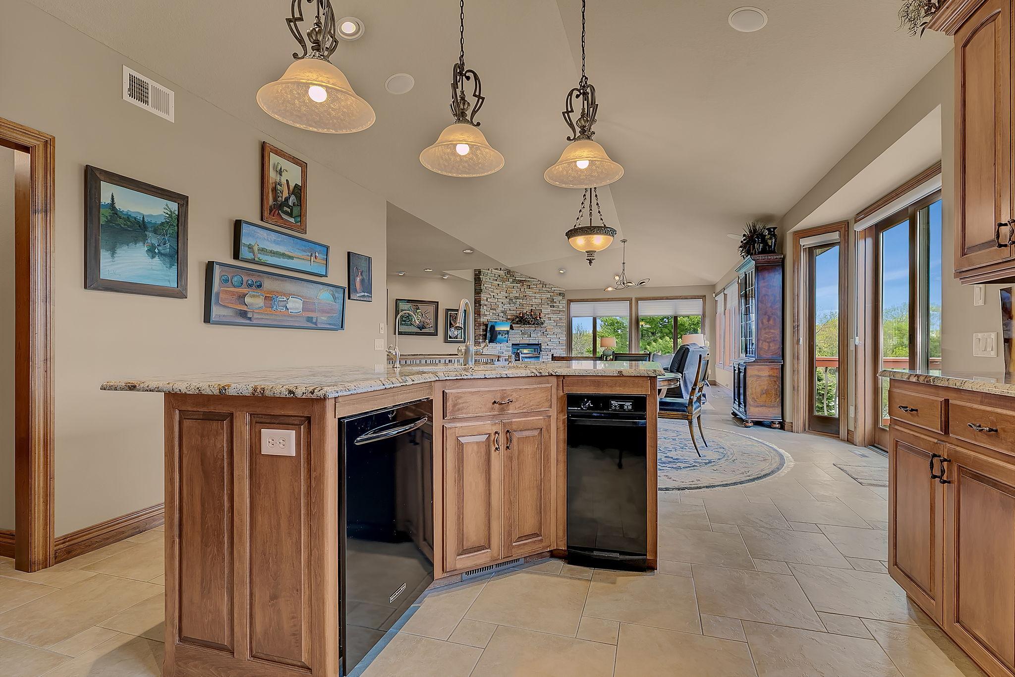 Stylish center island enhances the kitchen’s design and flow, sink, trash compactor, and dishwasher add to the function.
