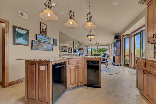 Stylish center island enhances the kitchenâs design and flow, sink, trash compactor, and dishwasher add to the function.