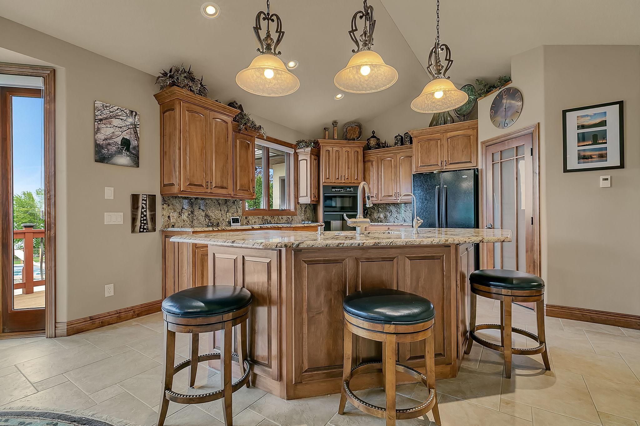 Breakfast bar for quick everyday meals. Gorgeous paneled maple cabinetry.