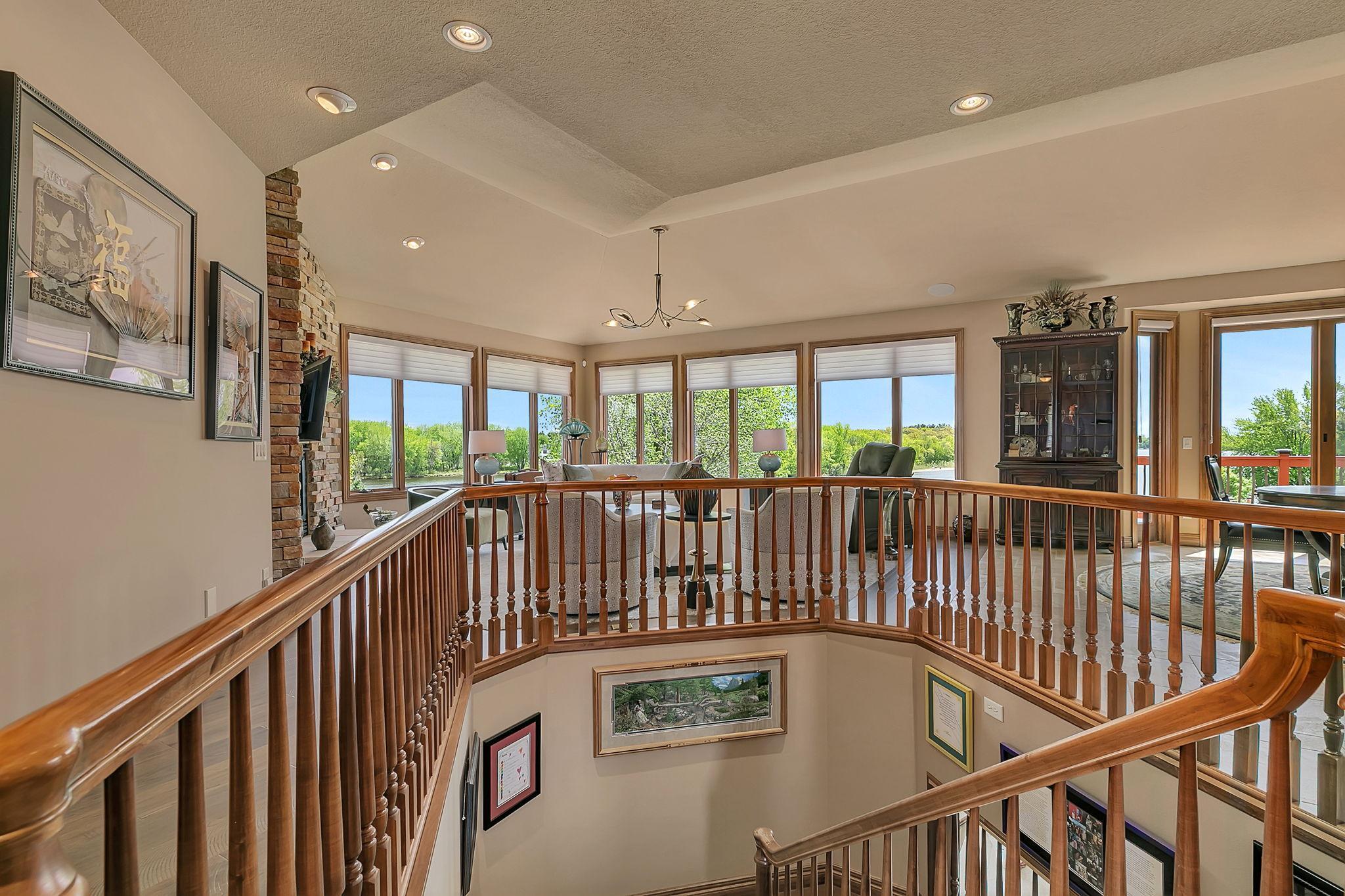 Windows on all sides capture beautiful views from every angle of the home. Grand open stairwell keeps the main floor open full of natural light at every angel.