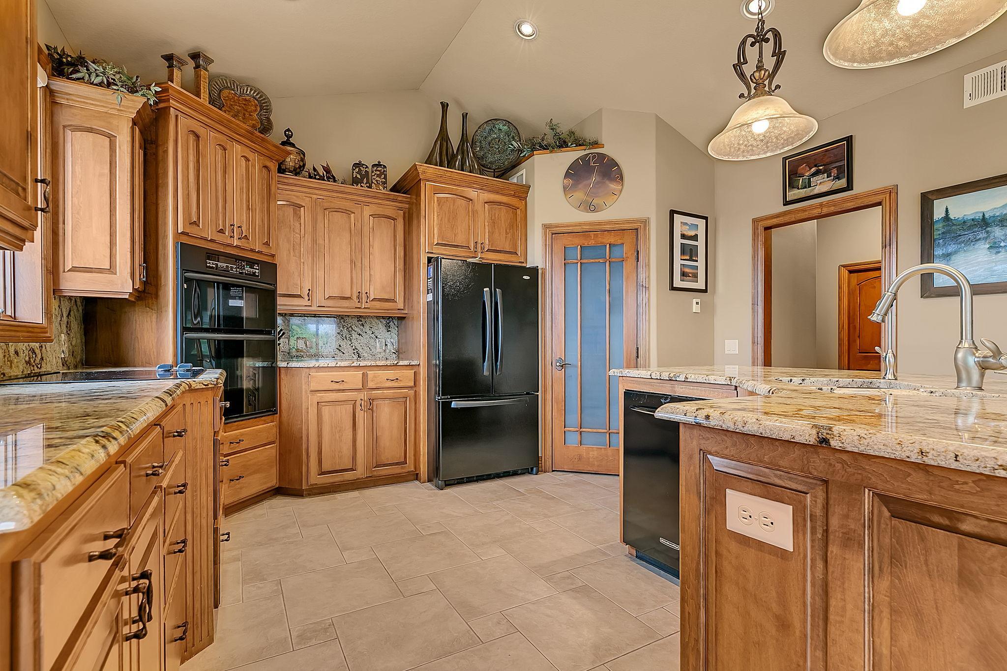 Ample cabinetry for all your culinary needs. Beveled granite tops add elegance.