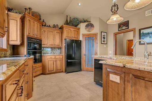 Ample cabinetry for all your culinary needs. Beveled granite tops add elegance.