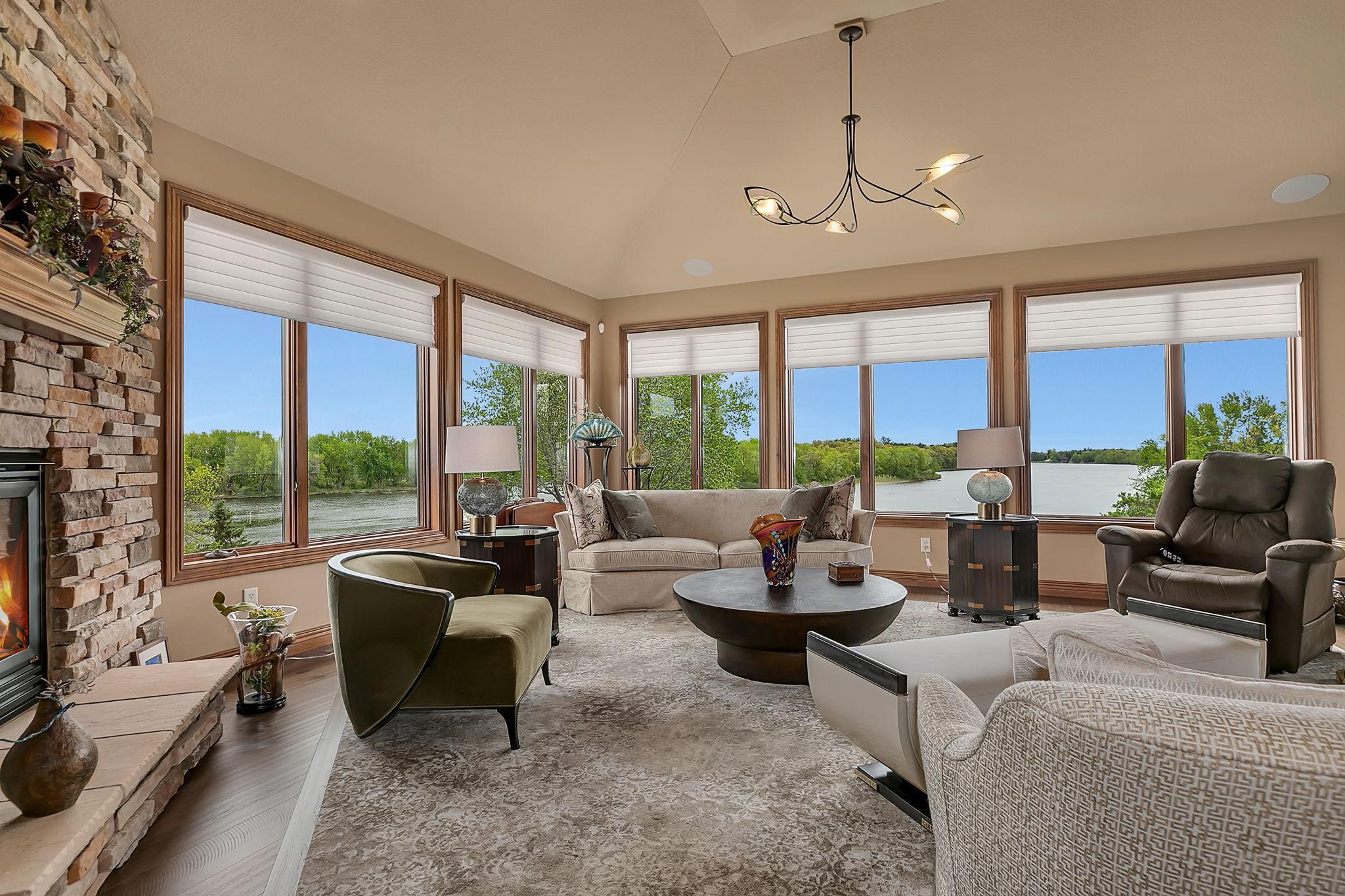 Stunning window design wraps the home in natural light. The surprise as you visit, is that the lower level living mirrors the same layout with the same stunning views.