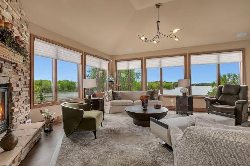 Stunning window design wraps the home in natural light. The surprise as you visit, is that the lower level living mirrors the same layout with the same stunning views.
