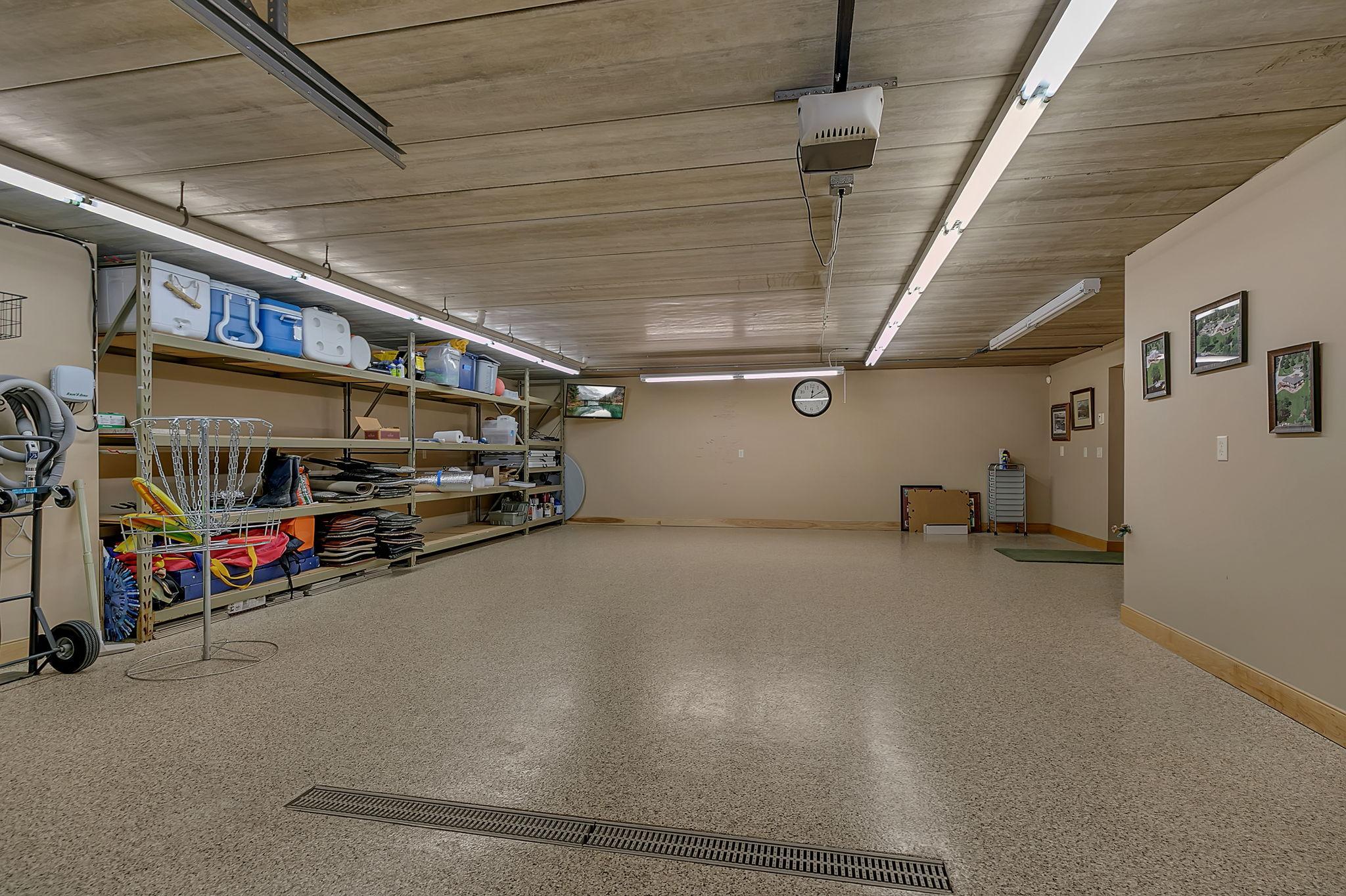 The heated tuck-under garage offers convenient access and is complemented by a smart driveway design for easy delivery of water gear and supplies.