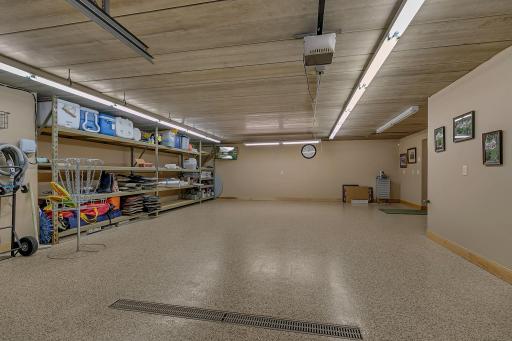 The heated tuck-under garage offers convenient access and is complemented by a smart driveway design for easy delivery of water gear and supplies.