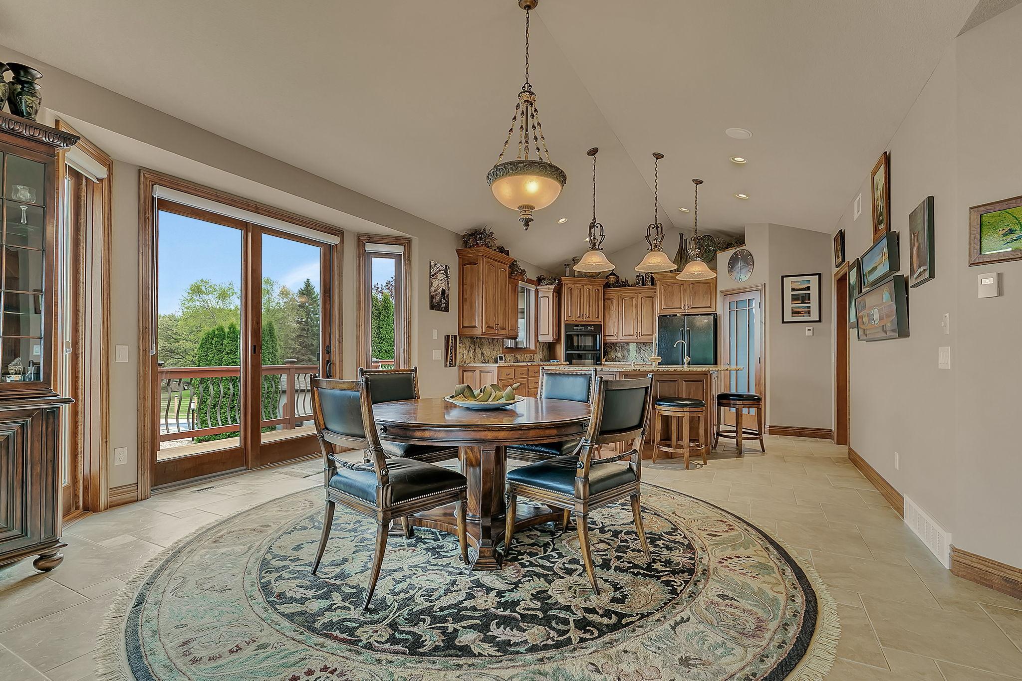 Dining room adjacent to the kitchen for easy access to meals. Space lends immediate access to deck.