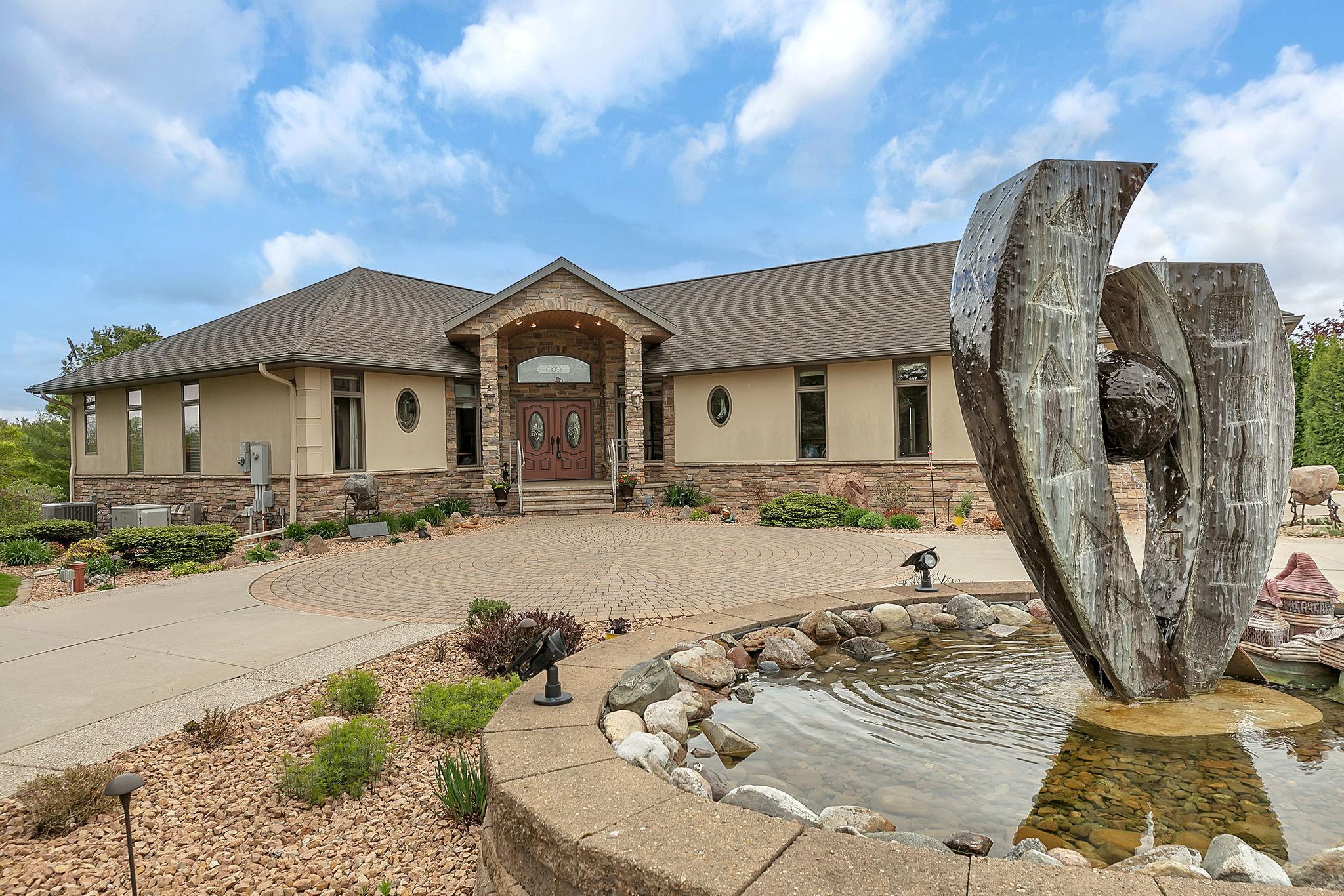 Decorative fountain enhances the home’s curb appeal. Wrap around driveway accommodates guests nicely.
