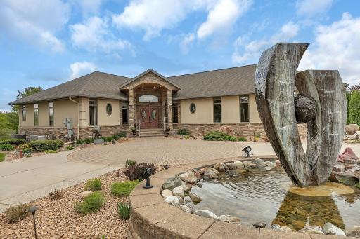 Decorative fountain enhances the homeâs curb appeal. Wrap around driveway accommodates guests nicely.