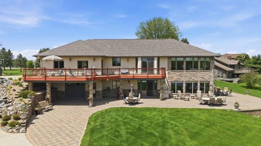 View of the back of the home. Hardscapes create function for entertaining. Perfectly complimented by a lush yard for playing.