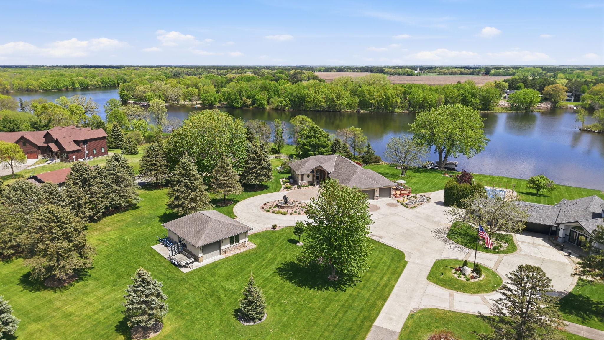 Mature trees and thoughtful landscaping frame the home’s entrance.