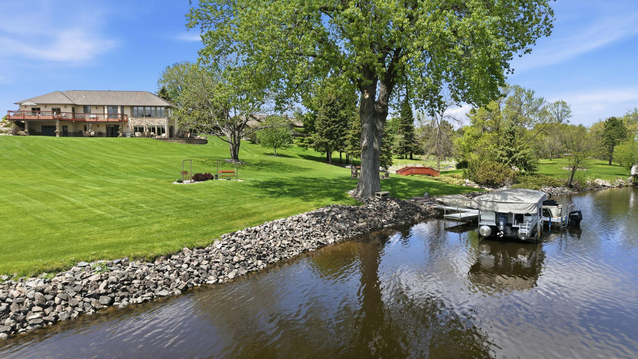 Enjoy peaceful river living in a scenic natural setting. Notice the soft gradual approach to the waterfront as the plush yard is a easy gradual slope.