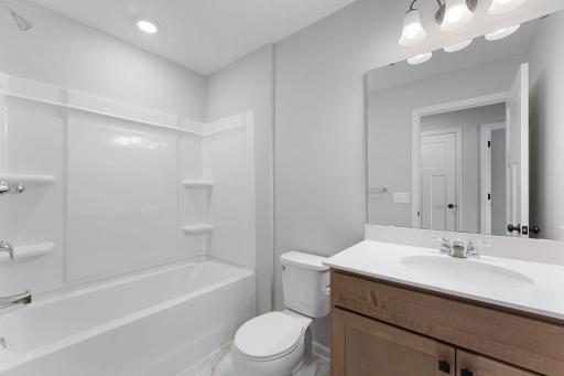 Main bath is just steps away from the secondary bedrooms. Similar home shown, options can vary.