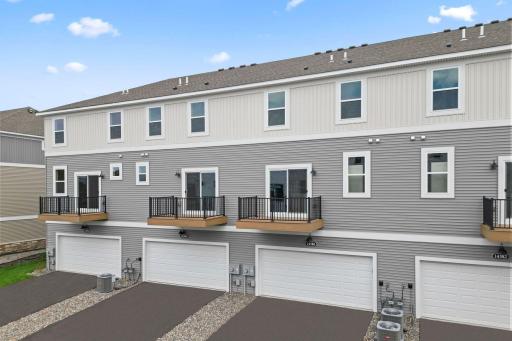 The back of the home features a 2-stall garage and maintenance free deck. Similar home shown, color can vary.