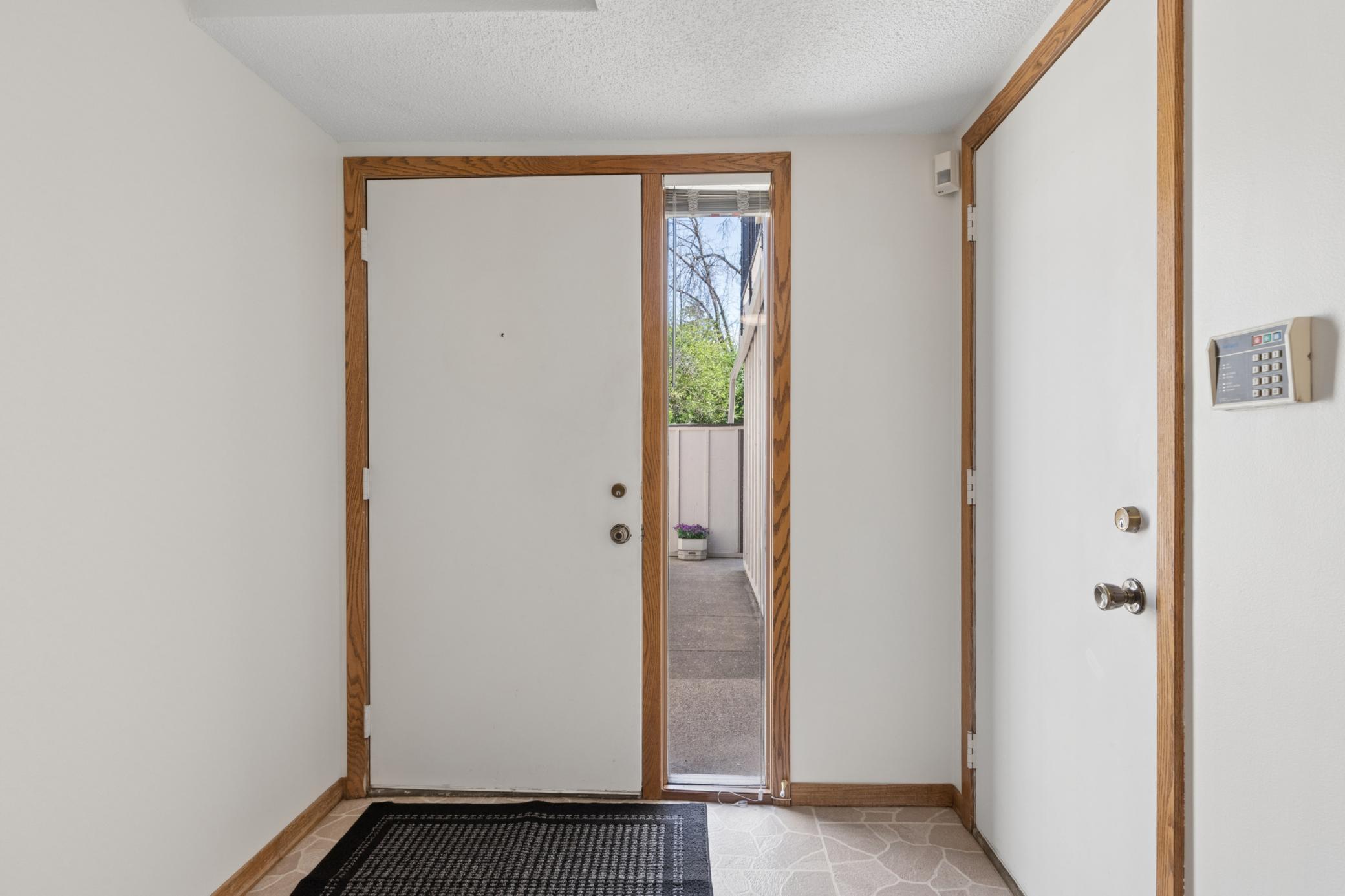 Spacious entry breezeway, side service door to garage.